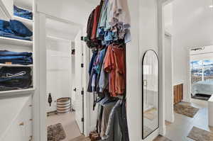 Walk in closet with light tile patterned floors