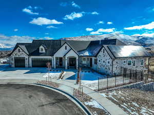 View of front of property with a mountain view and a garage