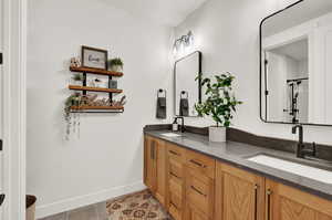 Bathroom featuring vanity and tile patterned flooring