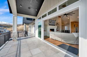 View of patio / terrace with a mountain view and ceiling fan