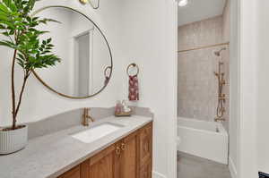 Full bathroom with vanity, toilet, and tiled shower / bath