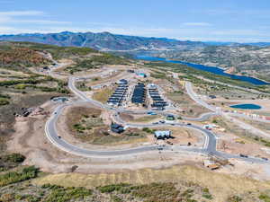 Birds eye view of property featuring a water and mountain view