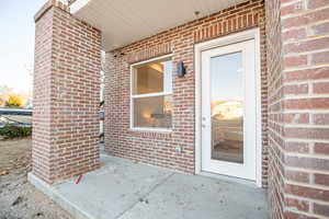 View of exterior entry featuring a patio