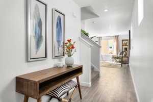 Hallway with light hardwood / wood-style flooring