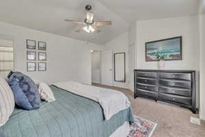 Primary Bedroom 2nd View: Bedroom featuring ceiling fan, light colored carpet, and vaulted ceiling