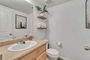 Main Floor Bathroom with toilet and vanity