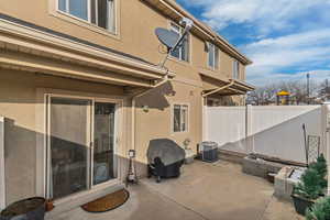 View of patio featuring a grill and central air condition unit