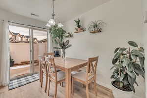 Dining area with light hardwood / wood-style flooring