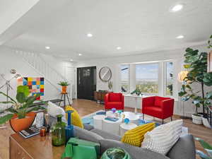 Living room with light hardwood / wood-style floors and a textured ceiling