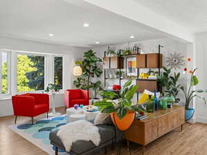 Interior space with a textured ceiling and light hardwood / wood-style flooring