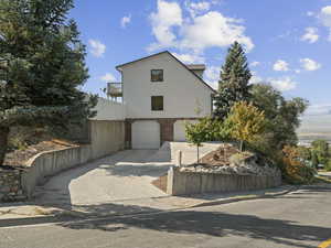 Front facade featuring a garage and a balcony