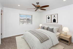 Carpeted bedroom with ceiling fan