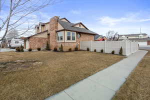 View of side of home with a yard