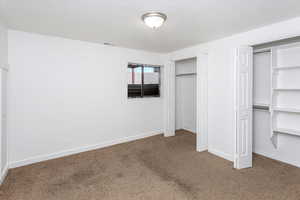 Unfurnished bedroom featuring carpet floors