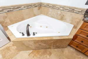 Bathroom with tiled bath and vanity