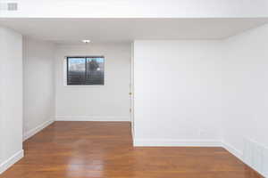 Unfurnished room featuring dark hardwood / wood-style floors