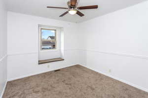 Empty room with ceiling fan and carpet flooring