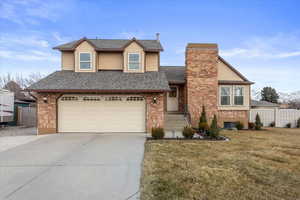 Front facade with a garage and a front lawn