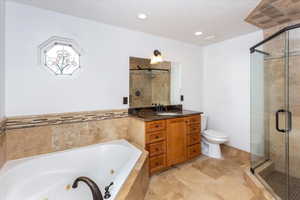 Full bathroom with toilet, vanity, and plus walk in shower