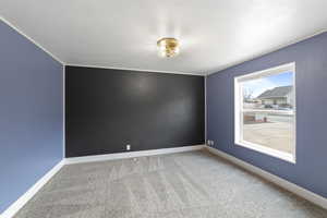 Empty room with a textured ceiling and carpet flooring