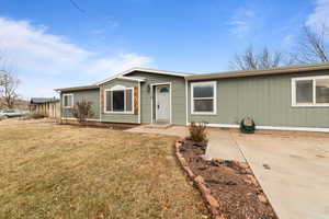 Single story home with a front yard