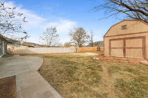 View of yard featuring a patio and an outdoor structure