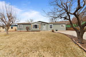 Single story home with a front lawn