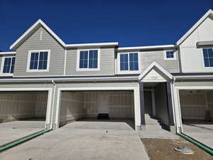 Townhome / multi-family property featuring a garage