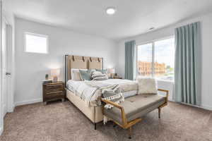 Bedroom featuring multiple windows and carpet