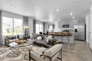 Living room with sink and light hardwood / wood-style flooring