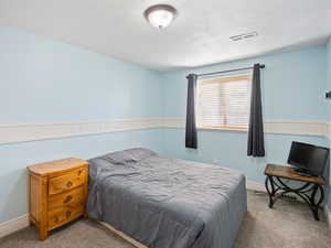 Bedroom with light colored carpet