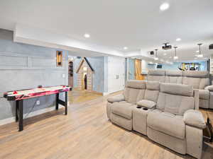 Home theater room featuring light hardwood / wood-style floors