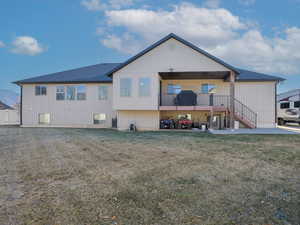 Rear view of property with a lawn