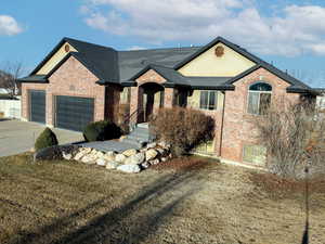 View of front of home featuring a garage and a front yard