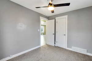 Unfurnished bedroom featuring ceiling fan and carpet