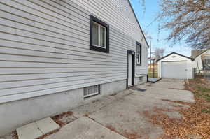 View of home's exterior featuring a garage and an outdoor structure