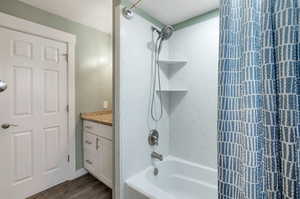 Bathroom featuring vanity, hardwood / wood-style flooring, and shower / bathing tub combination