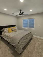 Bedroom with ceiling fan and carpet floors