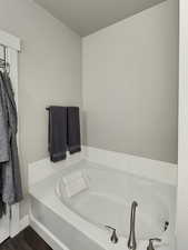 Bathroom featuring hardwood / wood-style flooring and a bathing tub