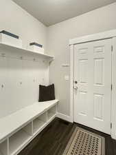 Mudroom featuring dark wood-type flooring and a textured ceiling