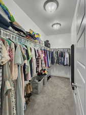 Spacious closet with light colored carpet