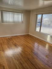 Unfurnished room featuring hardwood / wood-style flooring