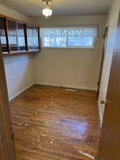 Unfurnished room with plenty of natural light and wood-type flooring
