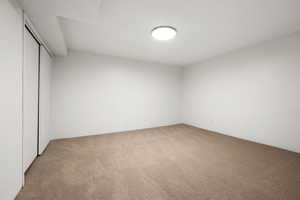 Unfurnished bedroom with carpet flooring and a closet