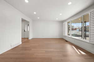 Unfurnished room with light wood-type flooring