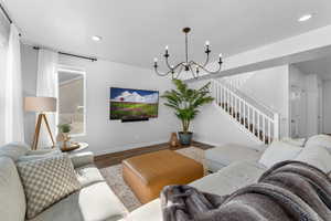 Living room featuring hardwood / wood-style floors and a chandelier