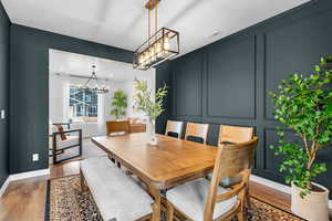 Dining space featuring an inviting chandelier and wood-type flooring