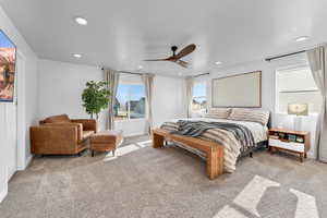 Bedroom with ceiling fan and light colored carpet