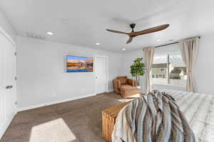 Bedroom featuring ceiling fan and carpet