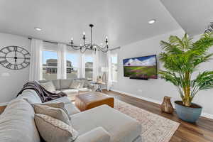 Living room featuring an inviting chandelier and dark hardwood / wood-style floors